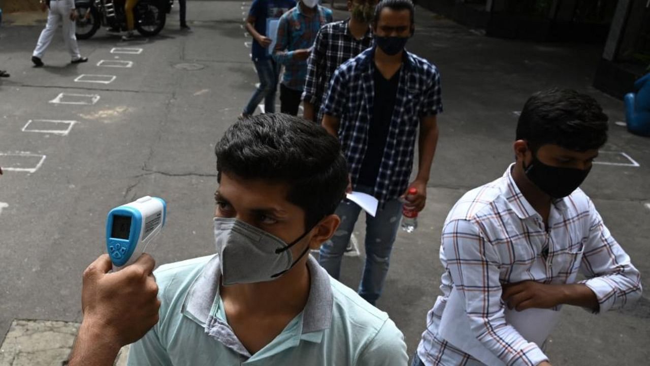 Students queue to enter an examination hall to sit for the state Joint Entrance Examination (JEE) test amid the Covid-19 coronavirus pandemic in Kolkata on July 17, 2021. Credit: AFP Photo