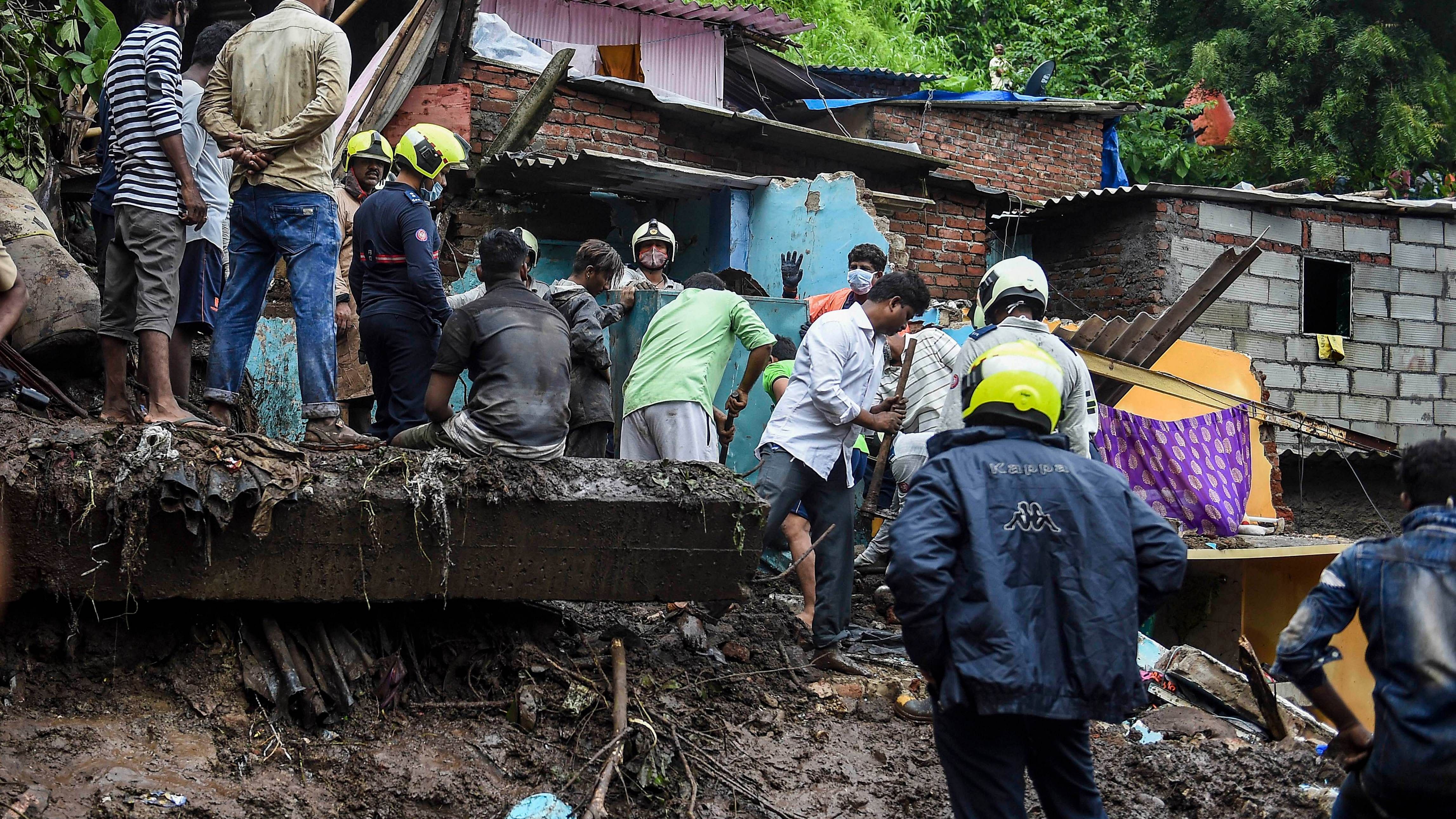 Firemen and rescue workers after a wall collapsed on some shanties in Chembur's Bharat Nagar area due to a landslide, in Mumbai. Credit: PTI File Photo