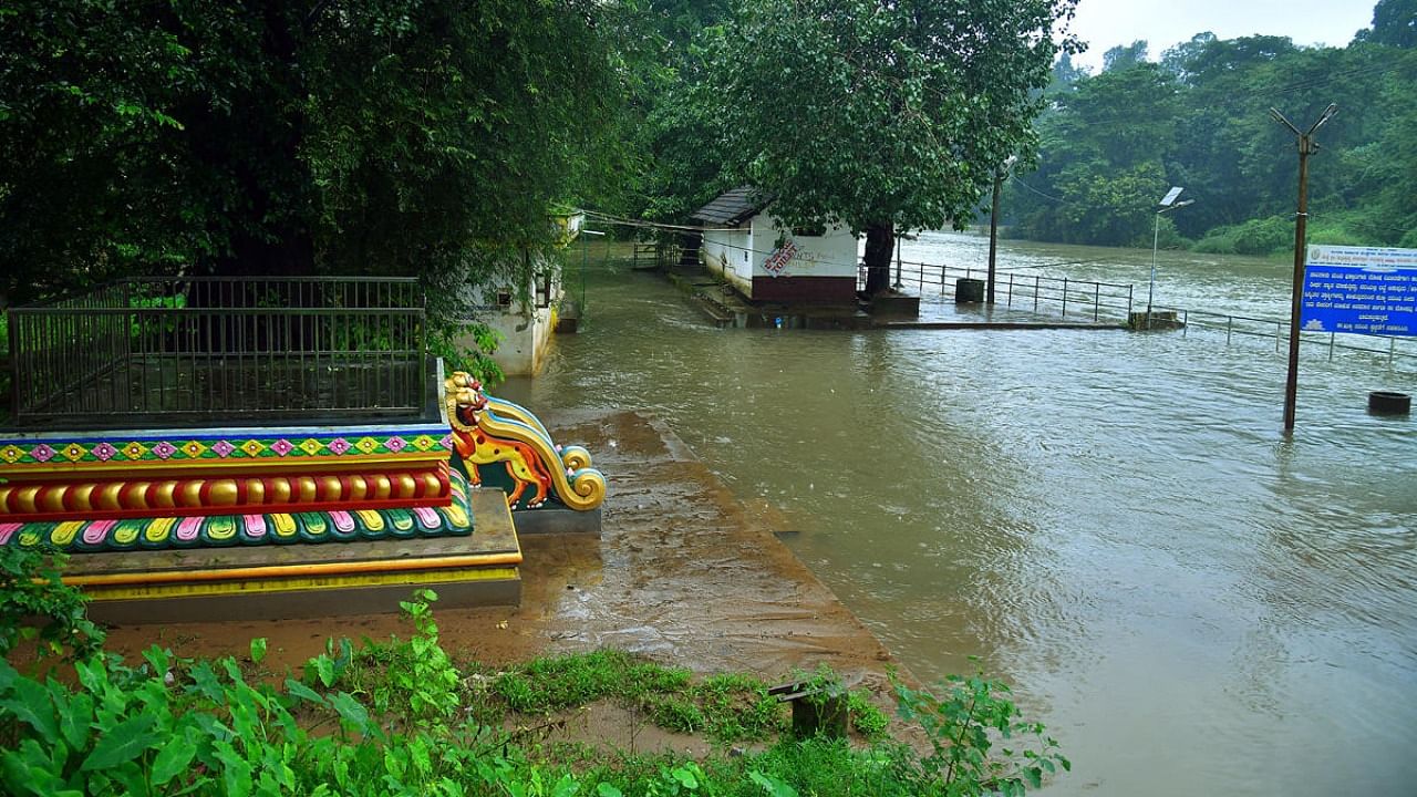 The snanaghatta at Kukke Subrahmanya was inundated with the rise in water-level in River Kumaradhara following heavy rains. Credit: DH Photo