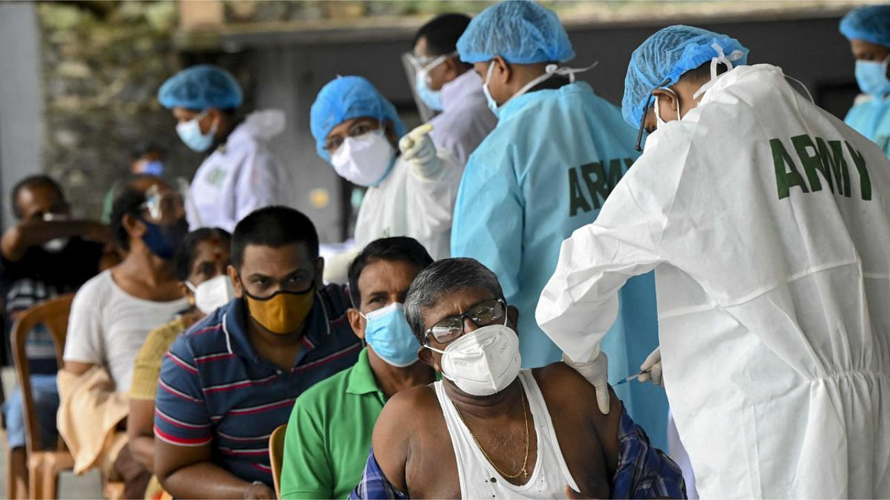 Army health officials inoculate people with the dose of the Sinopharm vaccine at a camp held in Colombo. Credit: AFP Photo