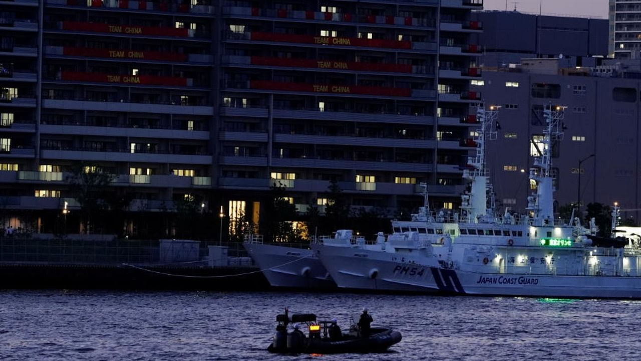 A boat from the Japan Coast Guard patrols the 2020 Tokyo Olympic Games Athletes' Village in Tokyo, Japan, July 19, 2021. Credit: Reuters Photo