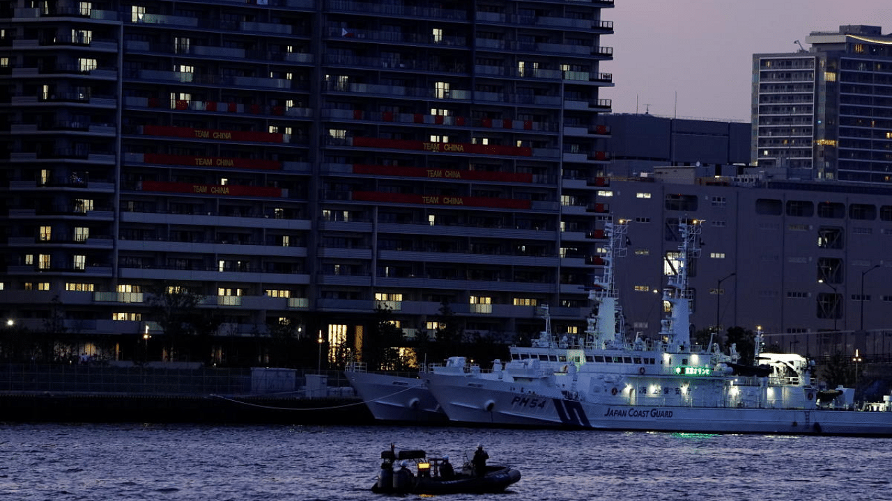 A boat from the Japan Coast Guard patrols the 2020 Tokyo Olympic Games Athletes' Village in Tokyo, Japan. Credit: Reuters Photo
