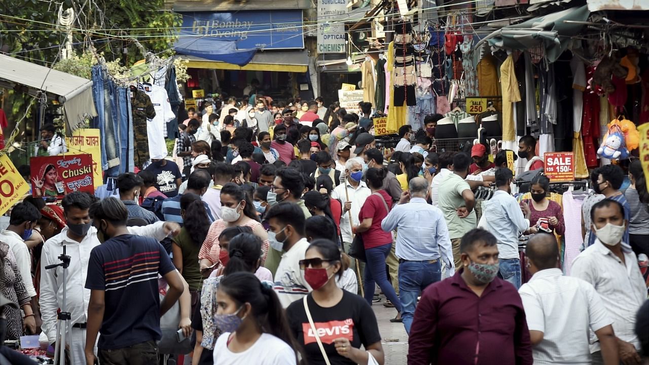 People, flouting Covid-19 appropriate behavior in a crowded Sarojini Market. Credit: PTI File Photo