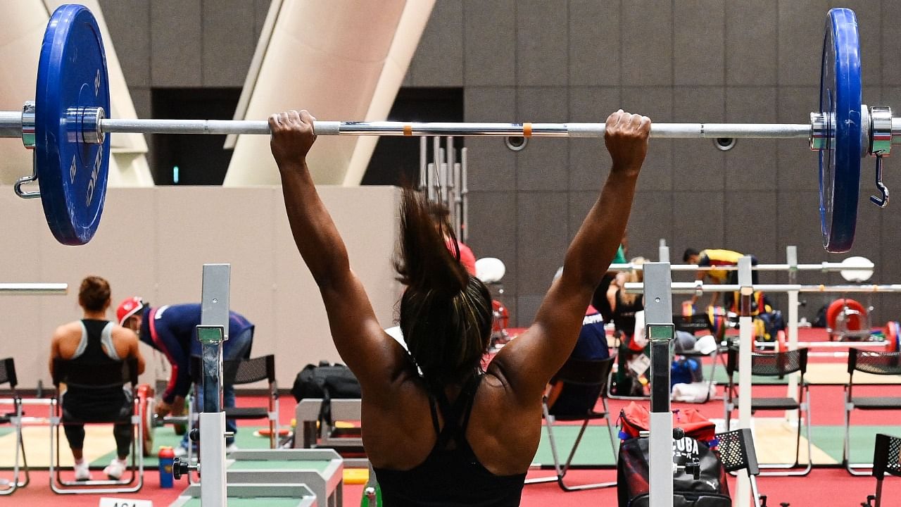 A member of the Cuba's weightlifting team takes part in a training session at the Tokyo International Forum ahead of the Tokyo 2020 Olympic Games in Tokyo on July 20, 2021. Credit: AFP Photo