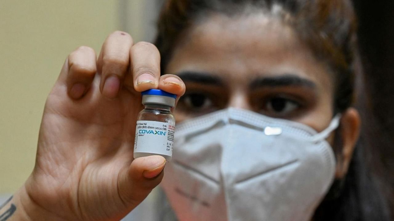 A health worker displays a vial of the Covaxin vaccine against the Covid-19 at a health centre in New Delhi. Credit: AFP Photo