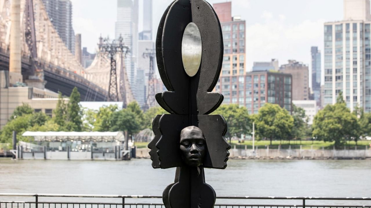 Artist Tanda Francis and her sculpture 'Rockit Black' in Queensbridge Park, Queens borough of New York. Credit: Reuters Photo