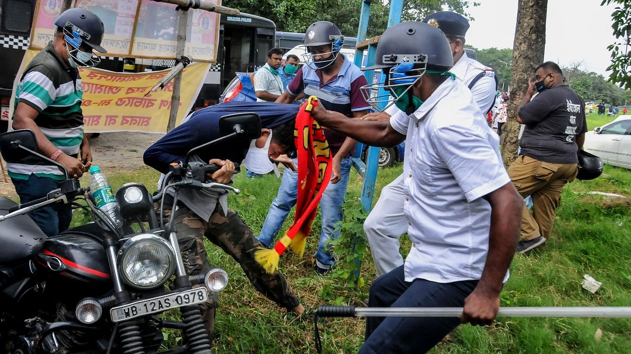 Police personnel detain East Bengal fans during their protest against managing authorities of the East Bengal Club, near club premises in Kolkata. Credit: PTI photo