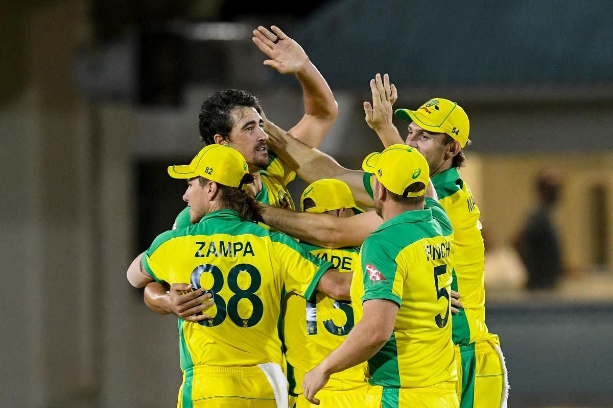 Mitchell Starc (L) of Australia celebrates with teammates winning the 4th T20I between Australia and West Indies at Darren Sammy Cricket Ground, Gros Islet, Saint Lucia. Credit: AFP Photo