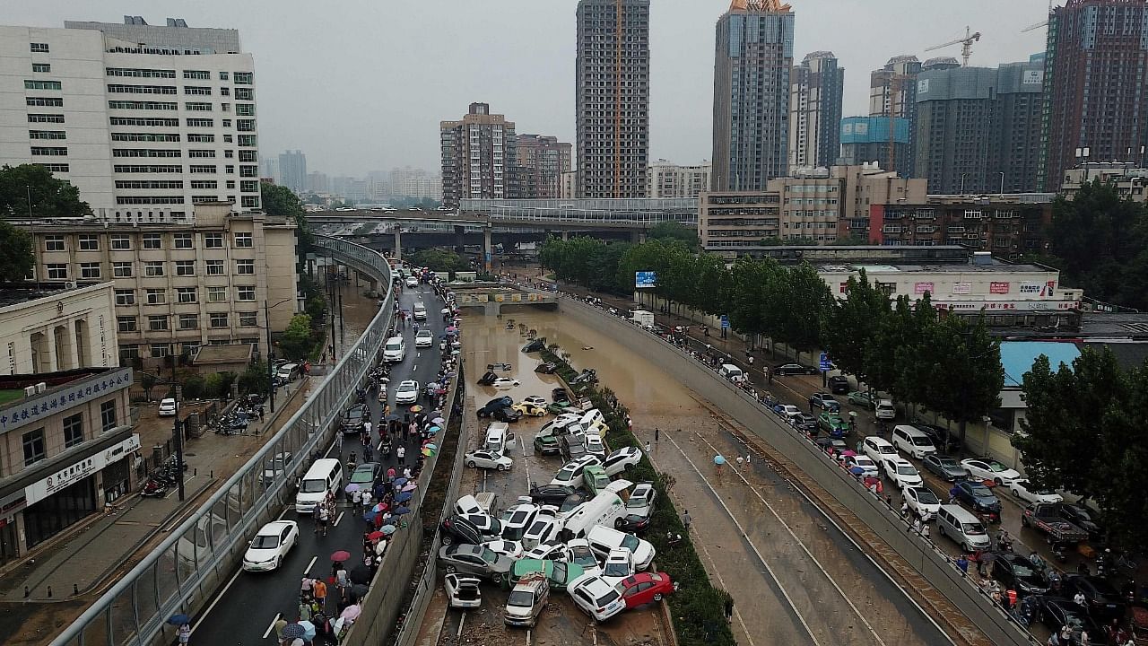 An aerial view shows cars sitting in floodwaters at the entrance of a tunnel after heavy rains hit the city of Zhengzhou in China's central Henan province on July 22, 2021. Credit: AFP Photo