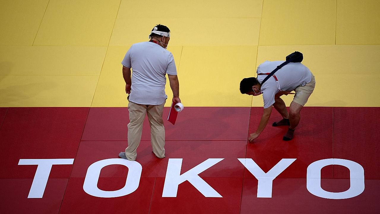 Judges, volunteers and technicians work inside the Nippon Budokan venue for judo and karate events in Tokyo on July 21, 2021, ahead of the Tokyo 2020 Olympic Games. Credit: AFP Photo