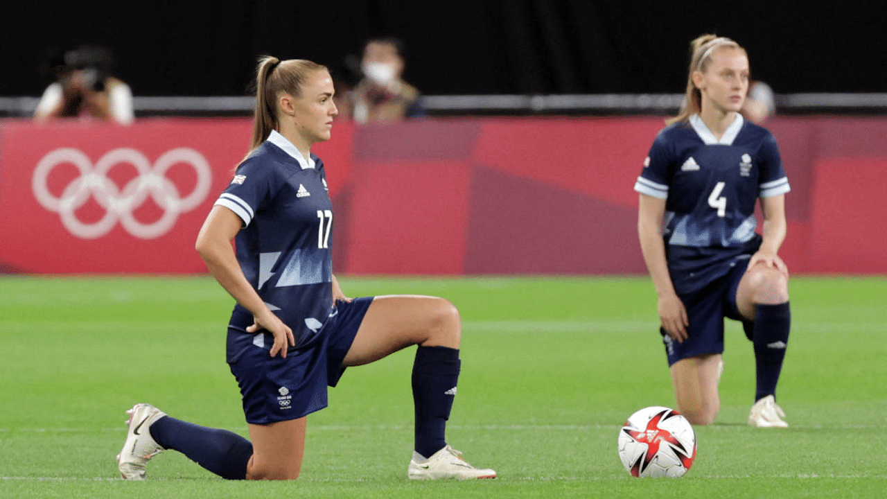  Britain's forward Georgia Stanway (L) and Britain's midfielder Keira Walsh take a knee before the Tokyo 2020 Olympic Games women's group E first round football match between Great Britain and Chile at the Sapporo Dome in Sapporo. Credit: AFP Photo