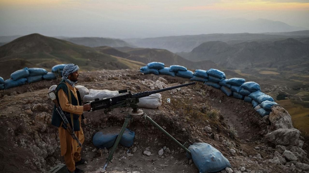 Afghan militia fighter keeps a watch at an outpost against Taliban insurgents at Charkint district in Balkh Province. Credit: AFP Photo