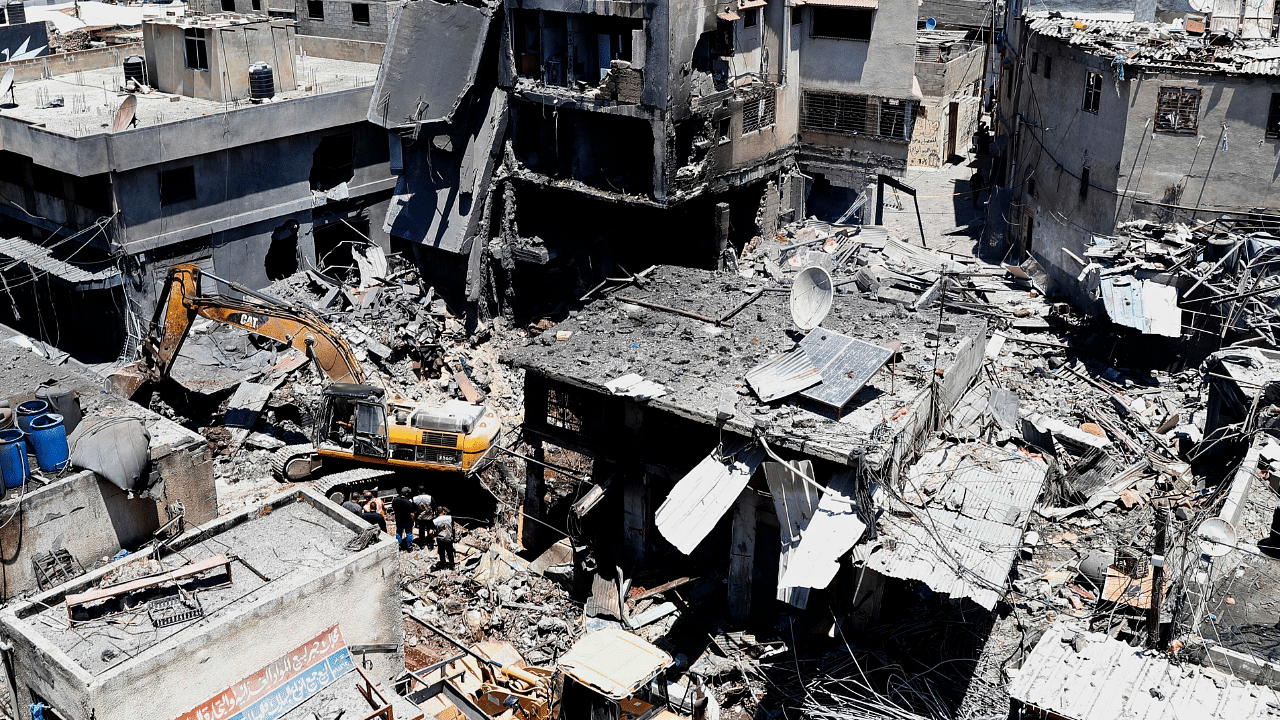  Palestinian rescuers and security personnel work at the scene of an explosion in the Al-Zawiya market area of Gaza City, Gaza. Credit: AP Photo
