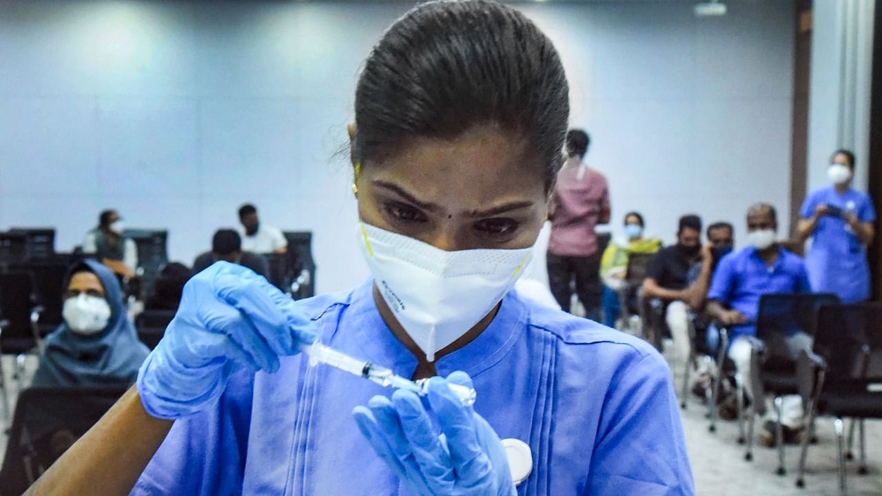 A health worker in Kerala prepares to administer a Covid-19 shot. Credit: PTI File Photo