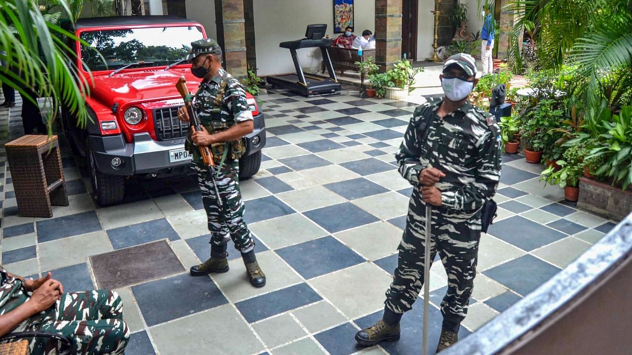 Security personnel stand guard at the residence of the owner of Dainik Bhaskar Group Sudhir Agarwal after Income Tax department raided his premises, in Bhopal, Thursday, July 22, 2021. Credit: PTI Photo