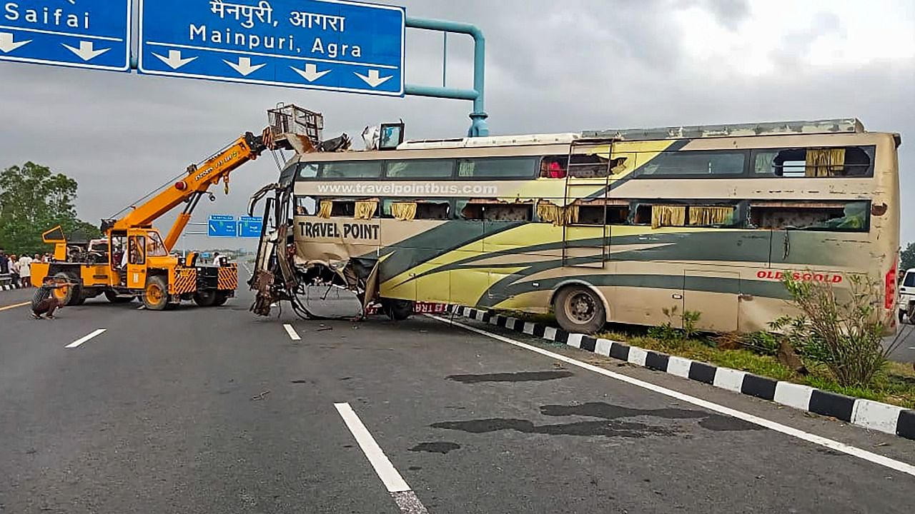 A crane pulls the mangled remains of a bus after an accident, in Mainpuri district. Credit: PTI Photo