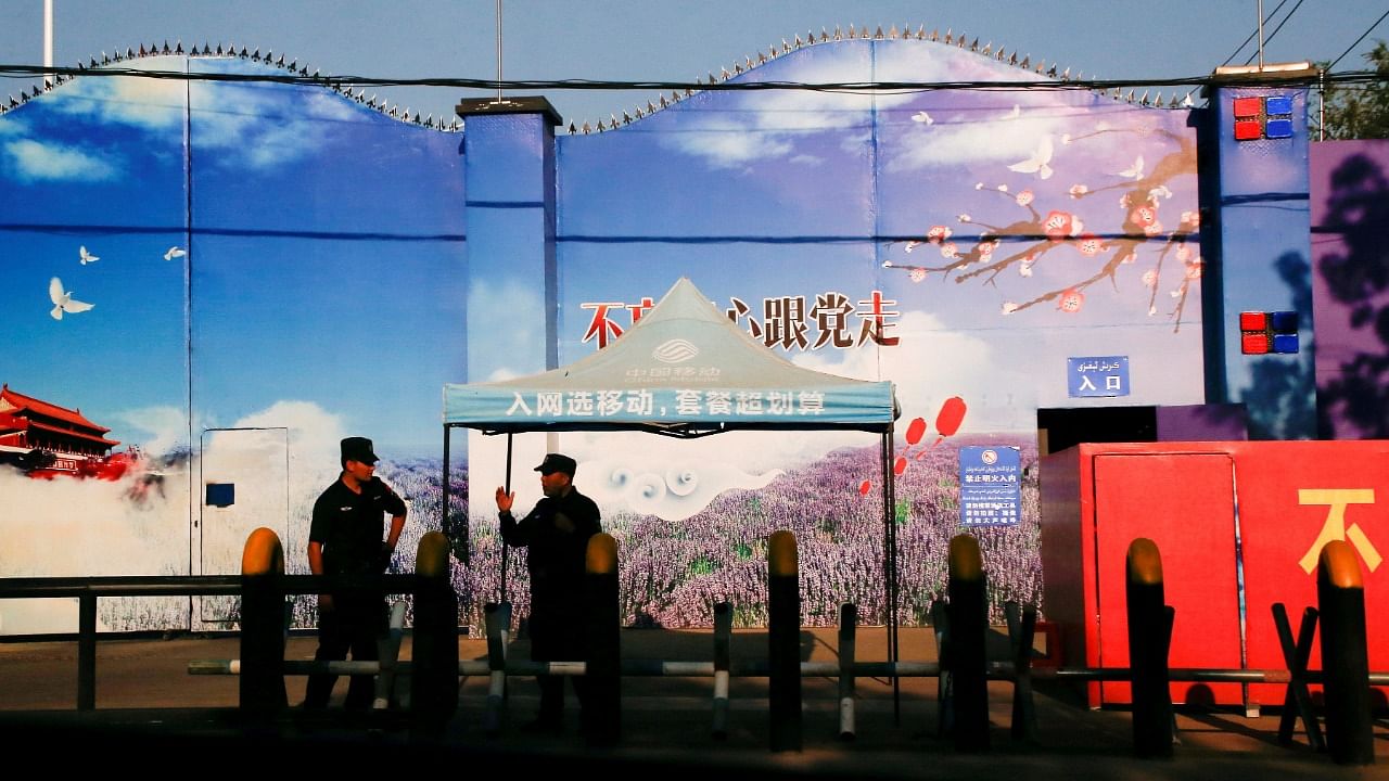 Security guards stand at the gates of what is officially known as a vocational skills education centre in Huocheng County. Credit: Reuters file photo