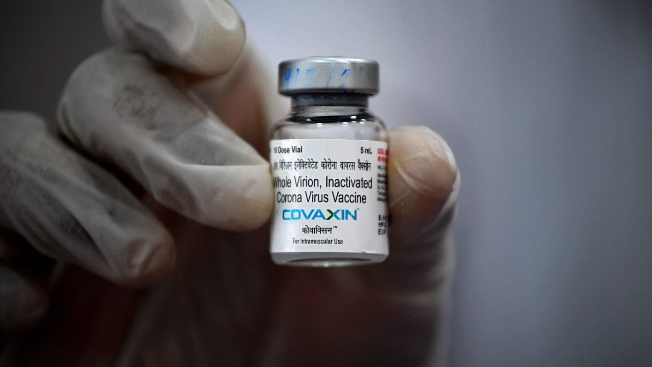 A medical worker displays a vial of the Covaxin Covid-19 vaccine. Credit: AFP File Photo