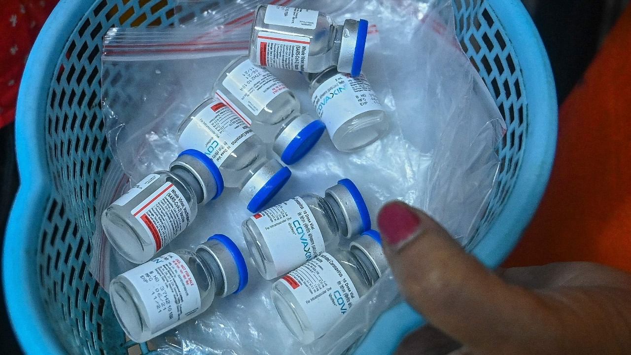 A health worker carries vials of the Covaxin vaccine. Credit: AFP Photo