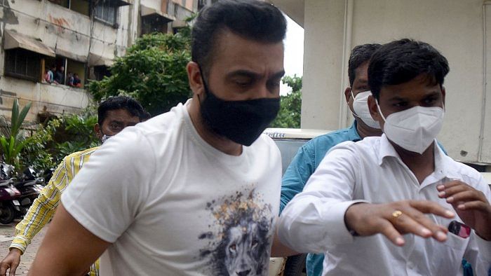Police escort arrested Raj Kundra (L) for allegedly producing and broadcasting pornographic films online, in Mumbai. Credit: AFP Photo