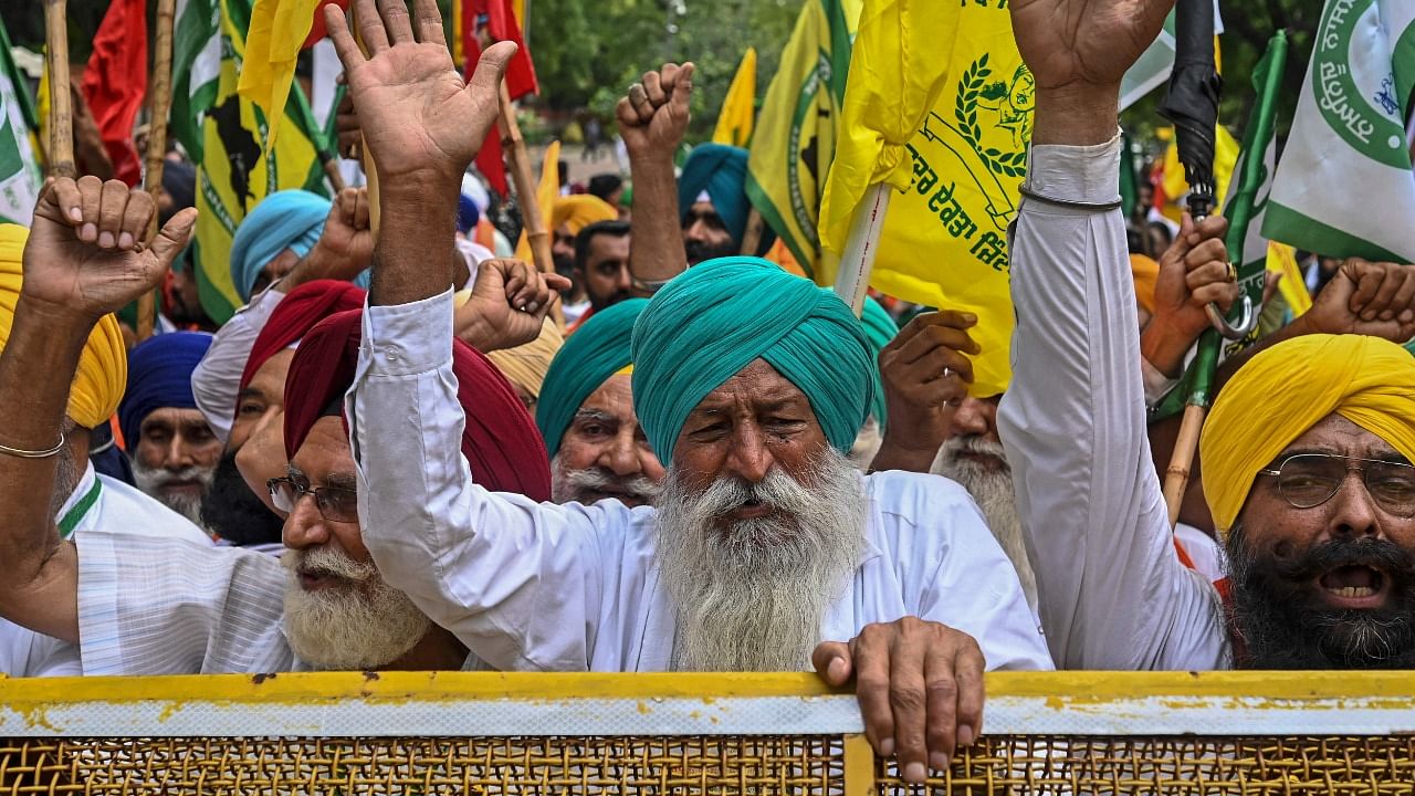 Protesting farmers stage a demonstration against the central government's recent agricultural reforms in New Delhi. Credit: AFP Photo