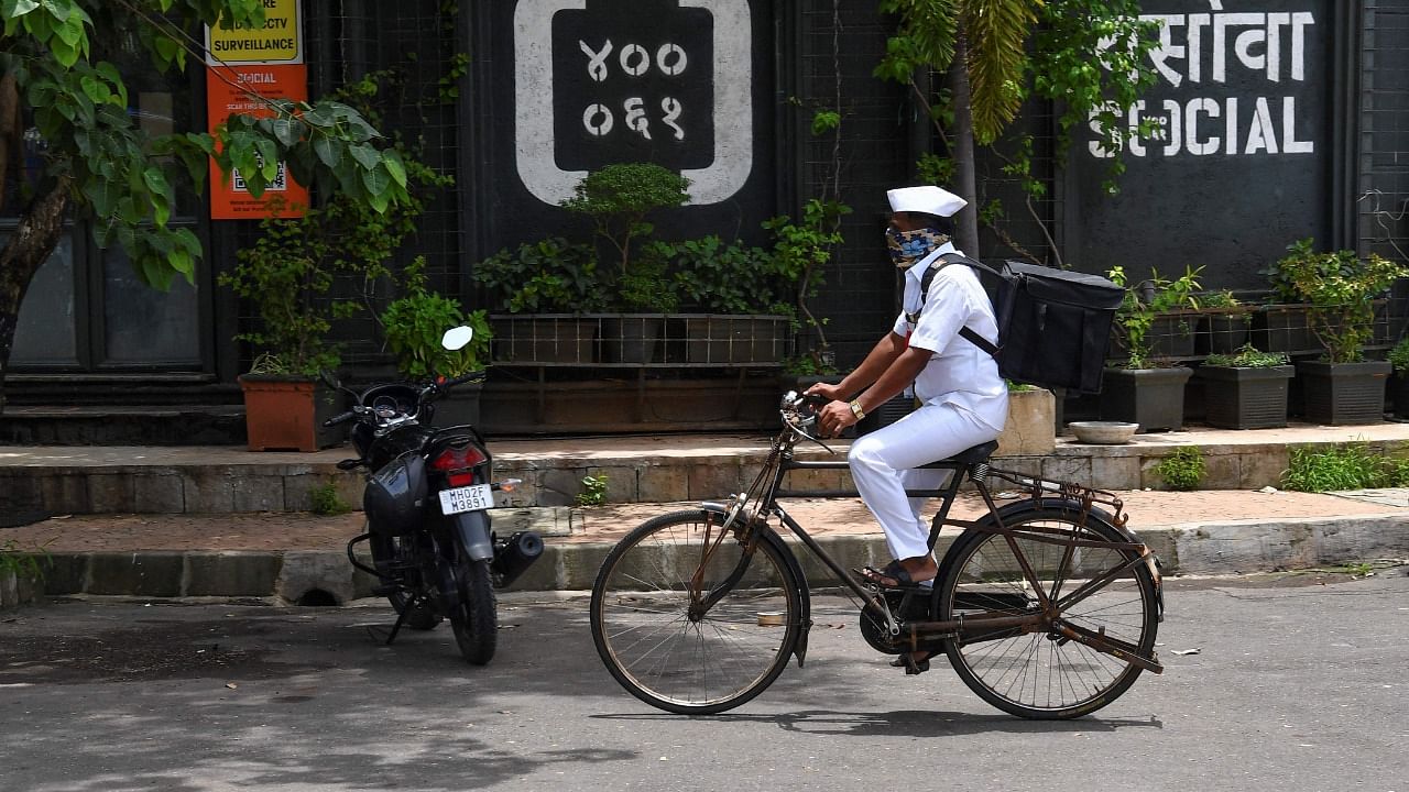 With extended lockdowns forcing millions of Mumbai's white-collar professionals to work from home, many dabbawalas have been struggling to feed their own families. Credit: AFP Photo