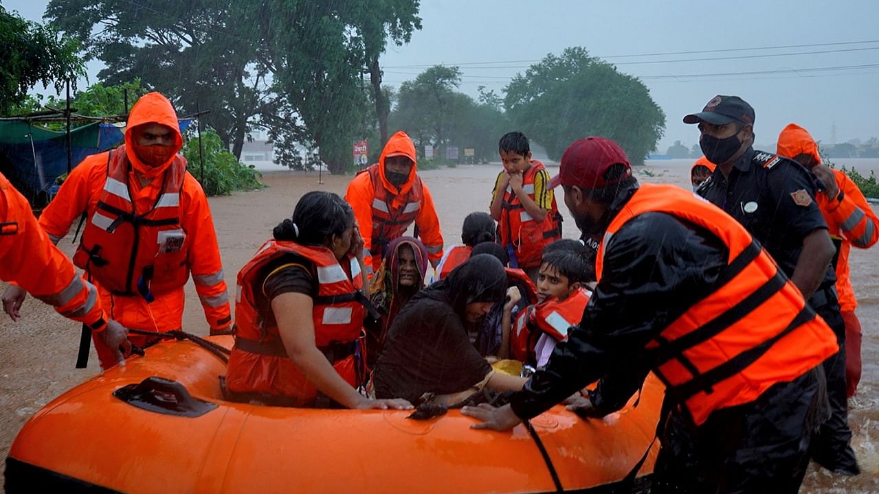 Rescue workers evacuate people from a flooded area to safer places after heavy rains in Kolhapur. Credit: Reuters photo