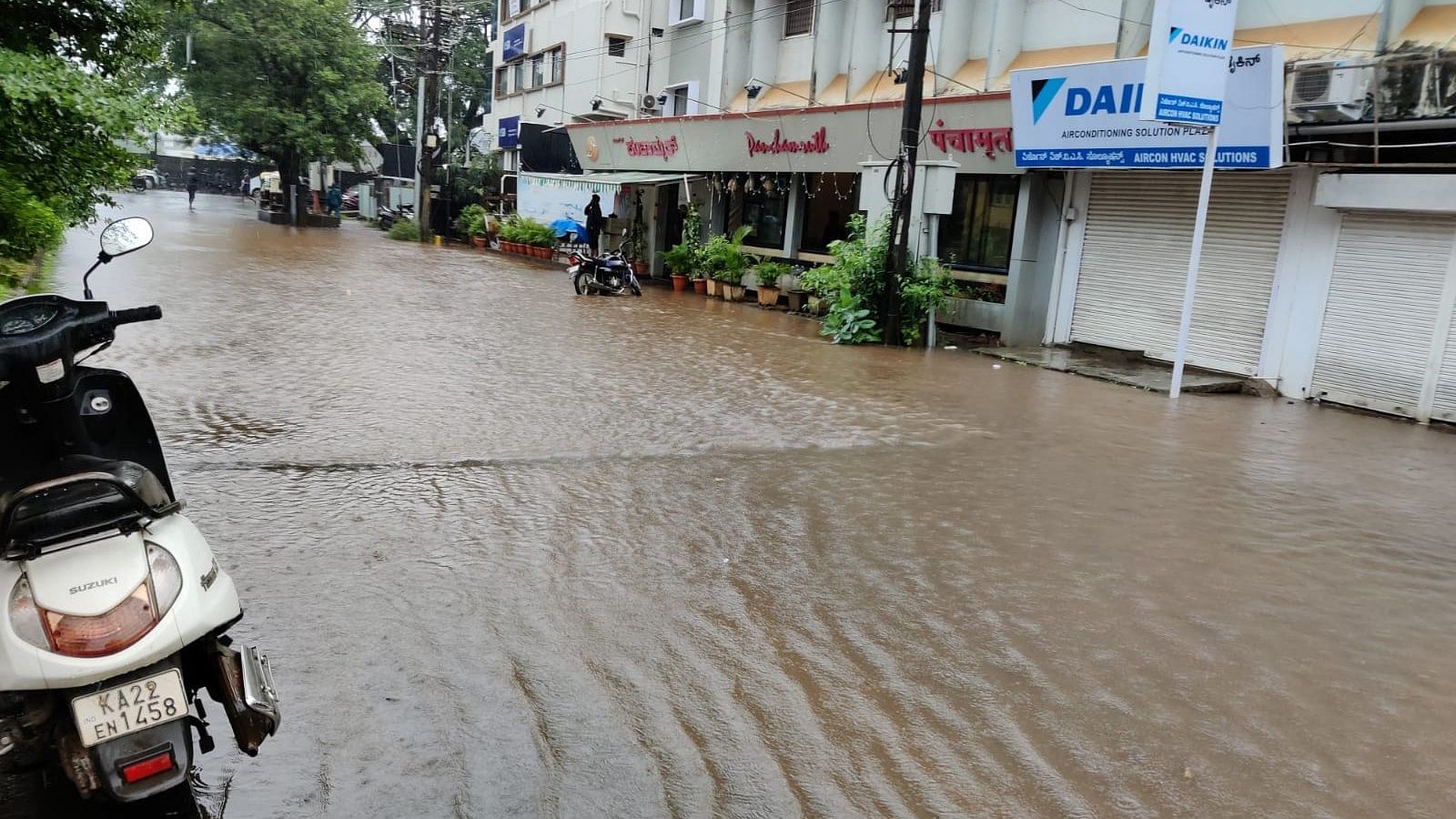 Maratha Colony in Belagavi got flooded with rainwater on Friday with no proper exit points for storm water. Credit: DH photo