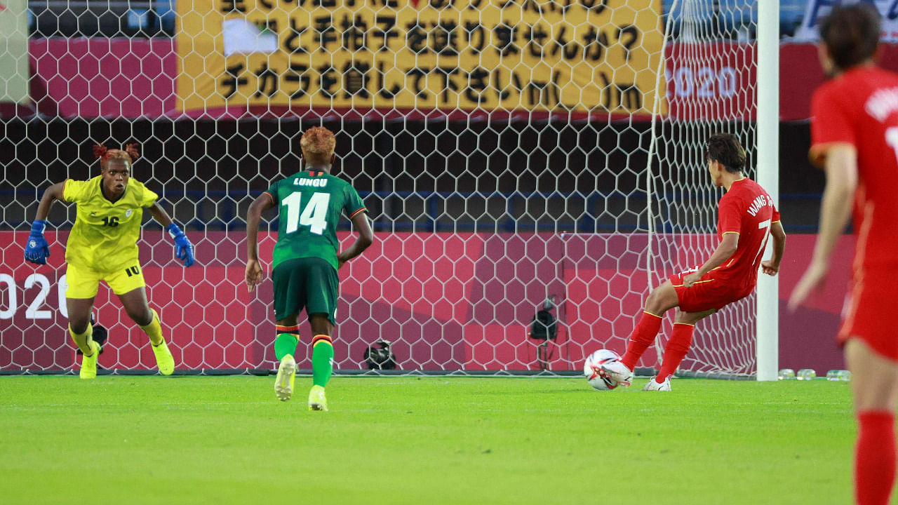 China's midfielder Wang Shuang (2nd-R) shoots to score a penalty past Zambia's goalkeeper Hazel Nali. Credit: AFP Photo