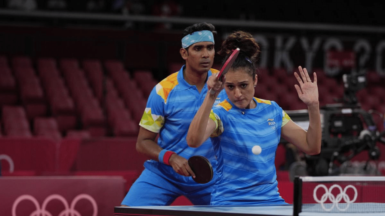  India's Kamal Achanta, left, and Manika Batra compete during table tennis mixed doubles round of 16 match against Taiwan's Lin Yun-Ju and Cheng I-ching at the 2020 Summer Olympics. Credit: AP Photo