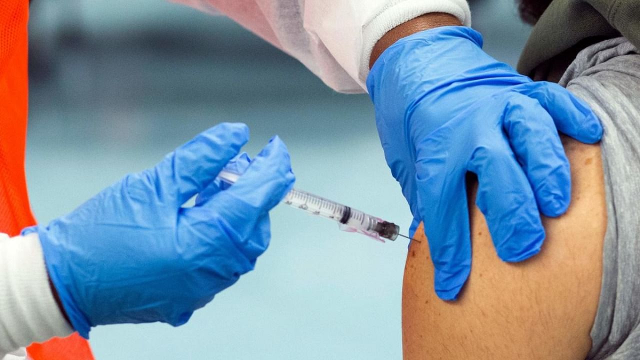 A man receives a dose of the Moderna Covid-19 vaccine at a vaccination site at South Bronx Educational Campus, in New York. Credit: AFP Photo