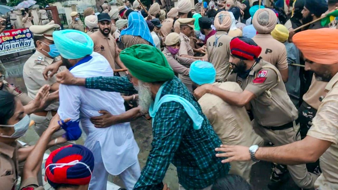 Police personnel try to stop the farmers showing black flags to newly appointed Punjab Congress President Navjot Singh Sidhu. Credit: PTI Photo