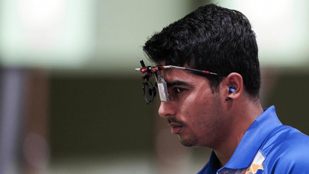 Saurabh Chaudhary pauses as he competes in the men's 10-meter air pistol at the Asaka Shooting Range in the 2020 Summer Olympics. Credit: AP Photo