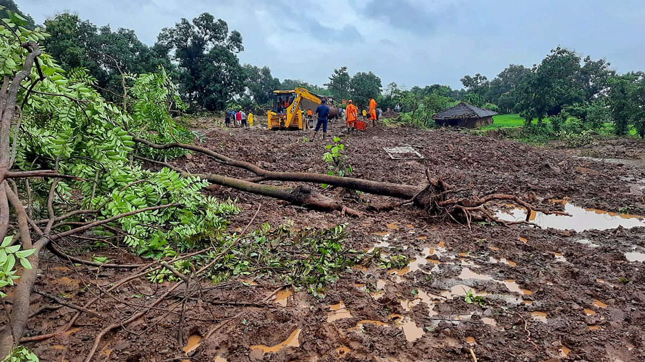 National Disaster Response Force (NDRF) personnel look for survivors at the landslide site in Taliye village near Mahad. Credit: AFP Photo