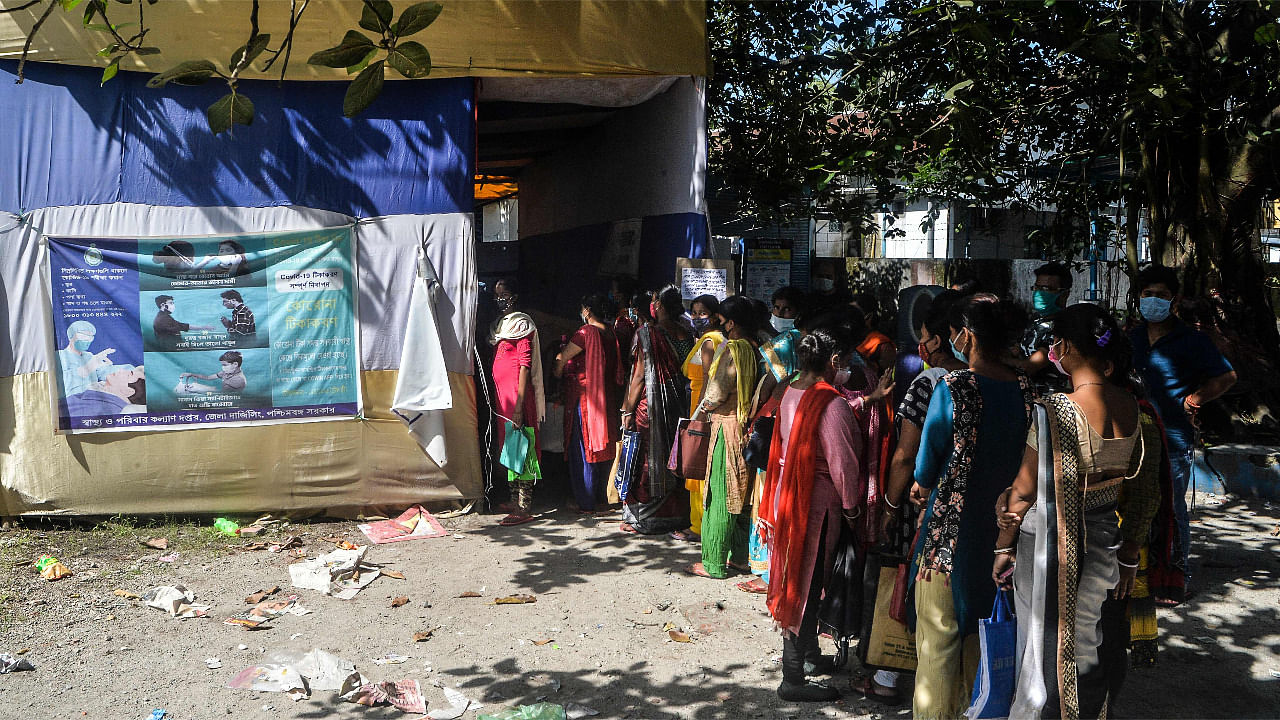 Women wait in a queue to register their children aged 0-12 years for a dose of the Covishield vaccine at a primary health centre in Siliguri. Credit: AFP Photo