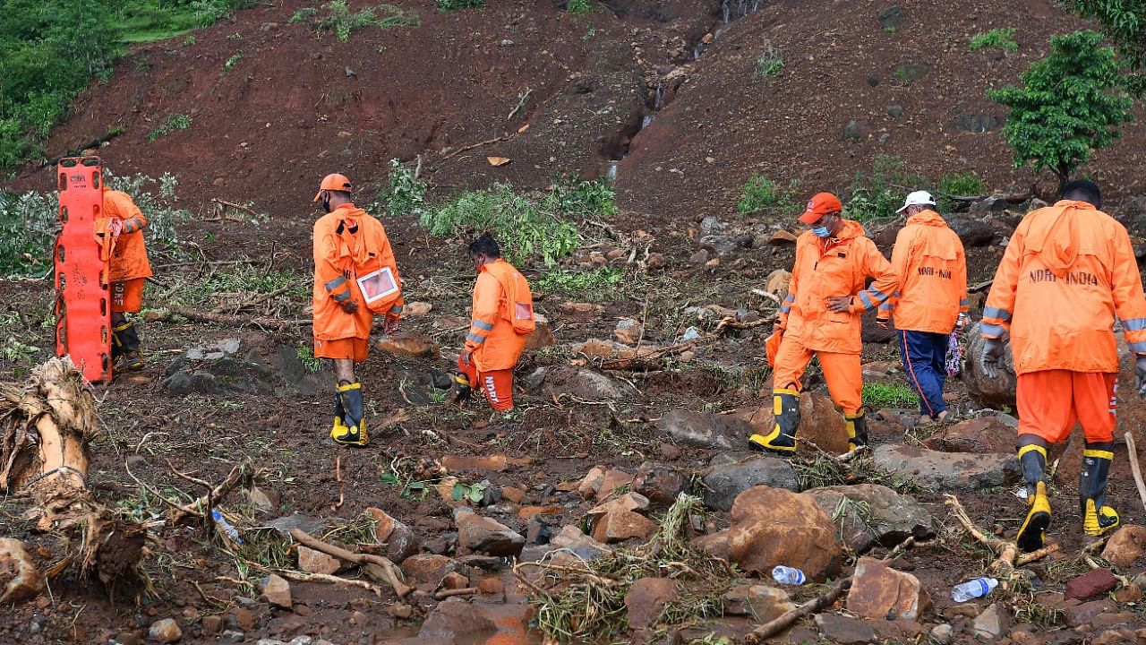 NDRF personnel search for victims after a landslide at Taliye. Credit: AFP Photo