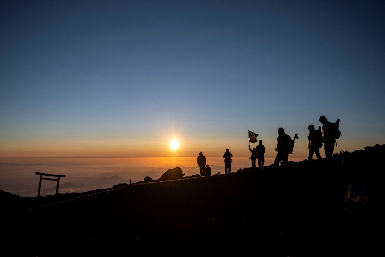 People watching the sunrise from the summit of Mount Fuji. Credit: AFP Photo