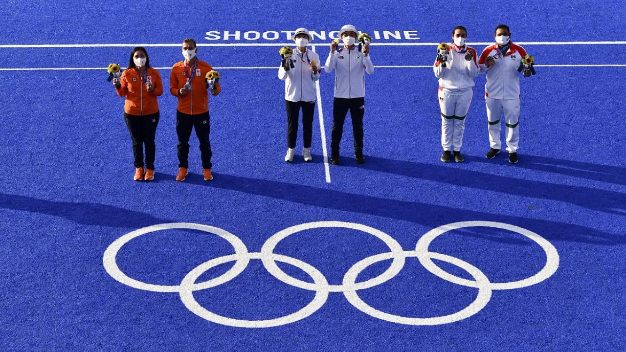 Gold medallist An San of South Korea and gold medallist Kim Je Deok of South Korea stand on the podium with silver medallist, Gabriela Schloesser of the Netherlands and silver medallist Steve Wijler of the Netherlands, and bronze medallist, Alejandra Valencia of Mexico and bronze medallist Luis Alvarez of Mexico. Credit: Reuters Photo