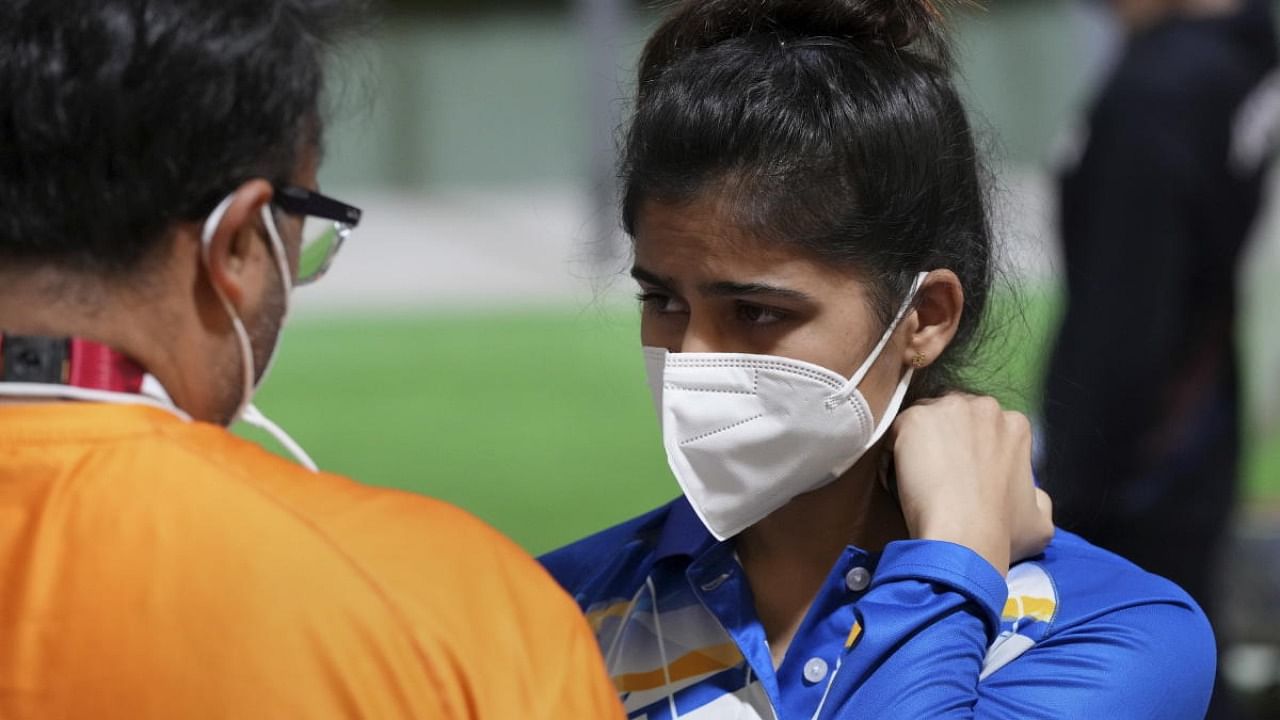  India's Manu Bhaker with Coach Ronak Pandit (L) reacts after the 10m Air Pistol Women's Qualification at the Summer Olympics 2020, in Tokyo, Sunday, July 25, 2021. Bhaker failed to qualify for the finals. Credit: PTI Photo