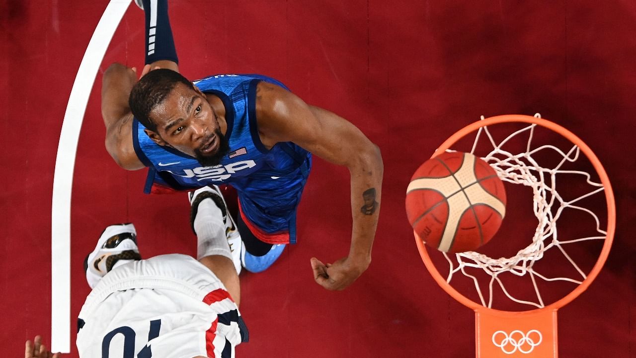 USA's Kevin Wayne Durant fights for a rebound during the men's preliminary round group A basketball match between France and USA during the Tokyo 2020 Olympic Games at the Saitama Super Arena. Credit: AFP Photo