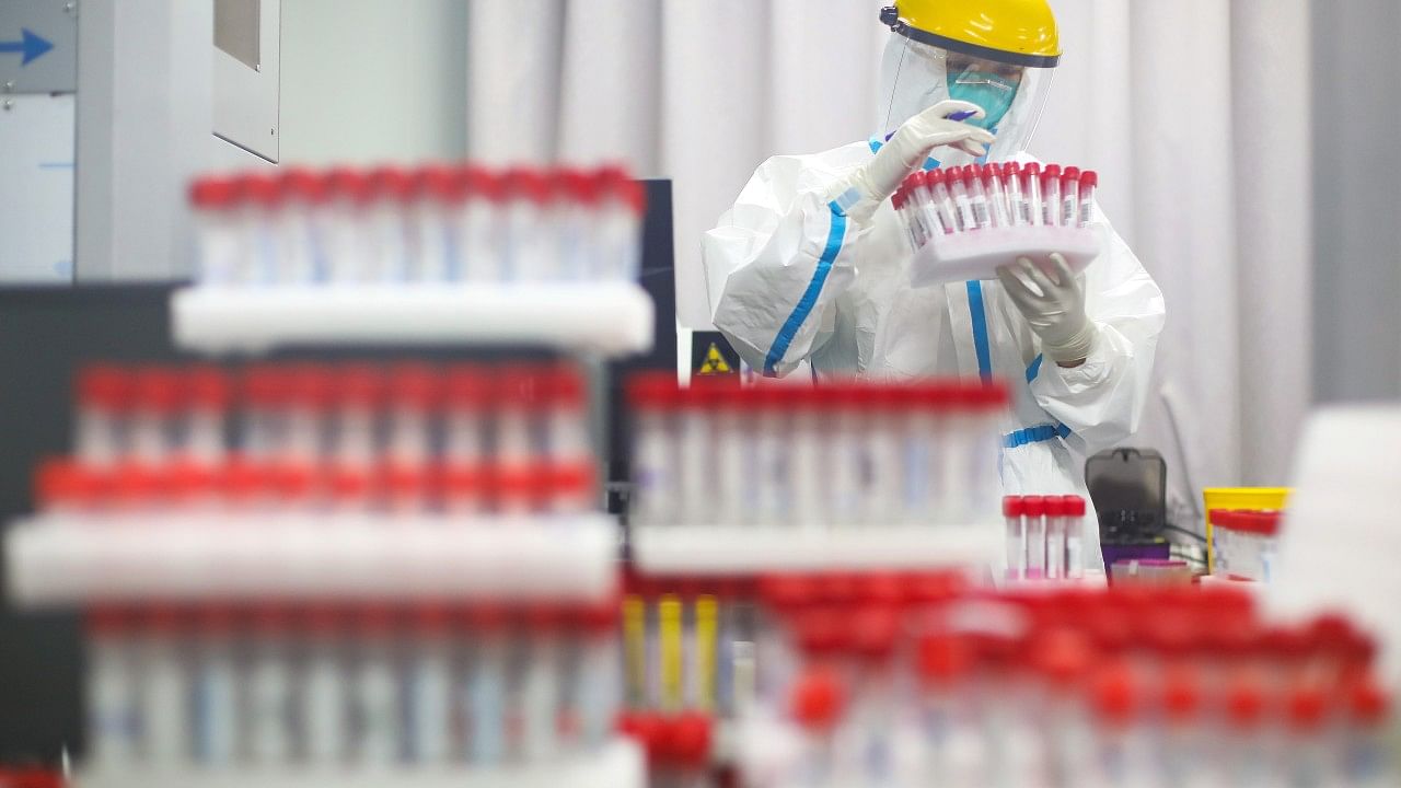 A medical staff in protective suit works at a nucleic acid testing laboratory of Nanjing First Hospital following a citywide mass testing for Covid-19 in Nanjing, Jiangsu province. Credit: Reuters Photo
