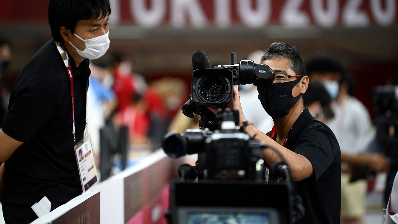 A TV host cameraman checks his camera inside the Nippon Budokan venue for judo and karate events during the Tokyo 2020 Olympic Games. Credit: AFP Photo