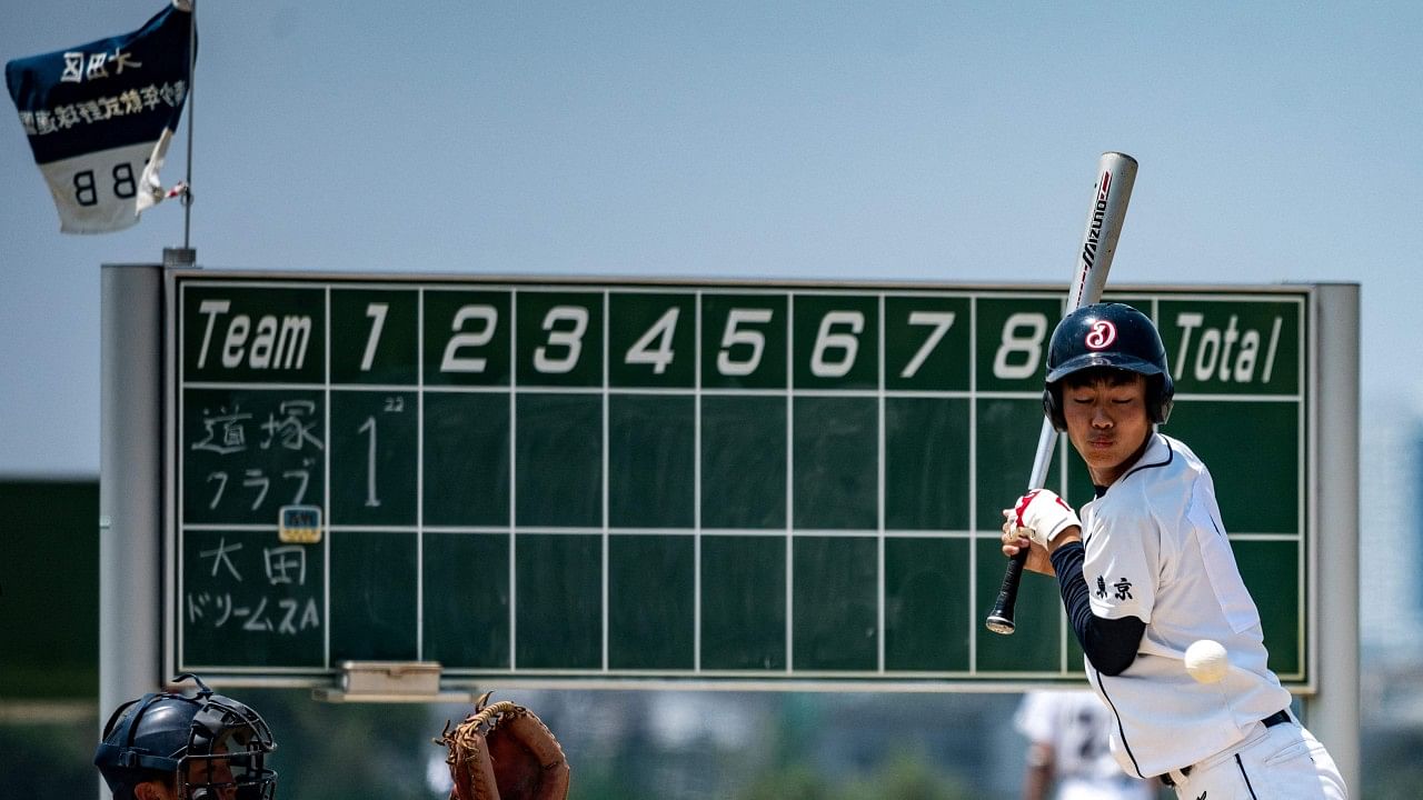 A player batting during in a high school baseball game between the Ota Dreams and Michiduka team at the Tamagawa Green Zone Baseball Field in Tokyo. Credit: AFP Photo