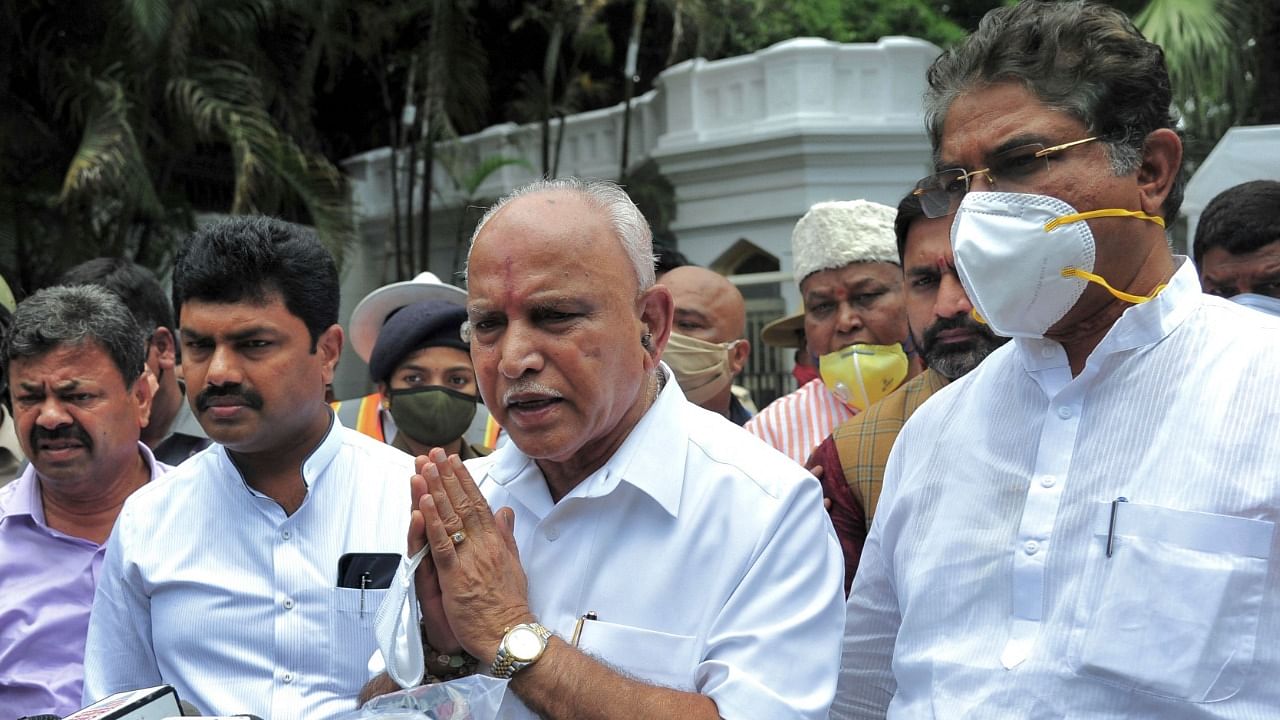 Karnataka chief minister BS Yediyurappa (C) gestures as he speaks to the medias outside the Governor's official residence Raj Bhavan after tendering resignation to his post in Bangalore on July 26, 2021. Credit: AFP Photo