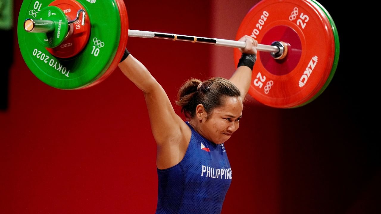 Hidilyn Diaz of Philippines competes in the women's 55kg weightlifting event, at the 2020 Summer Olympics. Credit: PTI photo