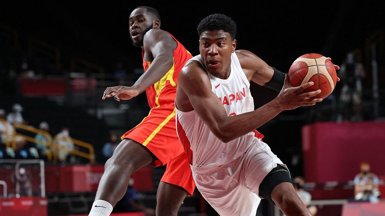 Japan's Rui Hachimura (R) runs with the ball in the men's preliminary round group C basketball match between Japan and Spain during the Tokyo 2020 Olympic Games at the Saitama Super Arena. Credit: AFP Photo