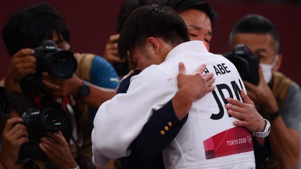 Japan's Hifumi Abe (white) celebrates winning the judo men's -66kg final bout against Georgia's Vazha Margvelashvili during the Tokyo 2020 Olympic Games at the Nippon Budokan in Tokyo. Credit: AFP Photo