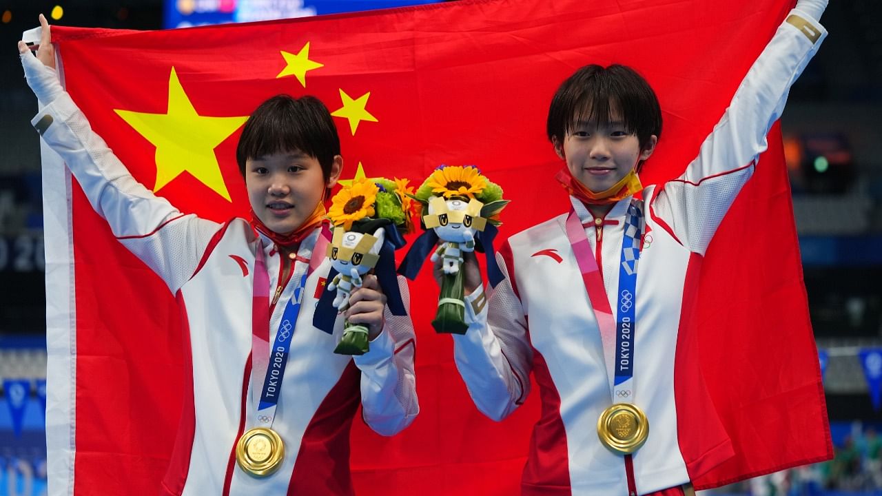 China's women's synchronised 10m platform diving gold medallists Chen Yuxi of China and Zhang Jiaqi. Credit: Reuters Photo