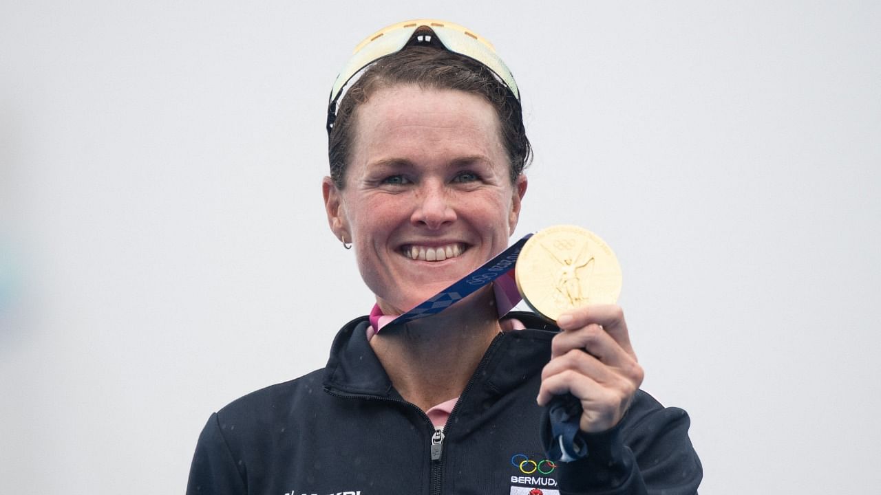Bermuda's Flora Duffy poses with her Olympic gold medal on the podium after winning the women's individual triathlon competition. Credit: AFP Photo