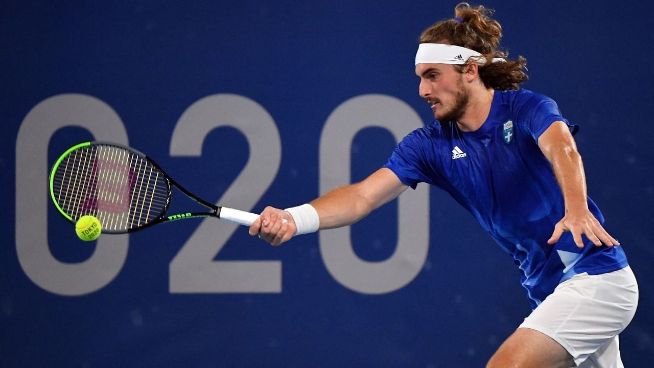 Greece's Stefanos Tsitsipas returns the ball to USA's Frances Tiafoe during their Tokyo 2020 Olympic Games men's singles second round tennis match at the Ariake Tennis Park in Tokyo on July 27, 2021. Credit: AFP Photo